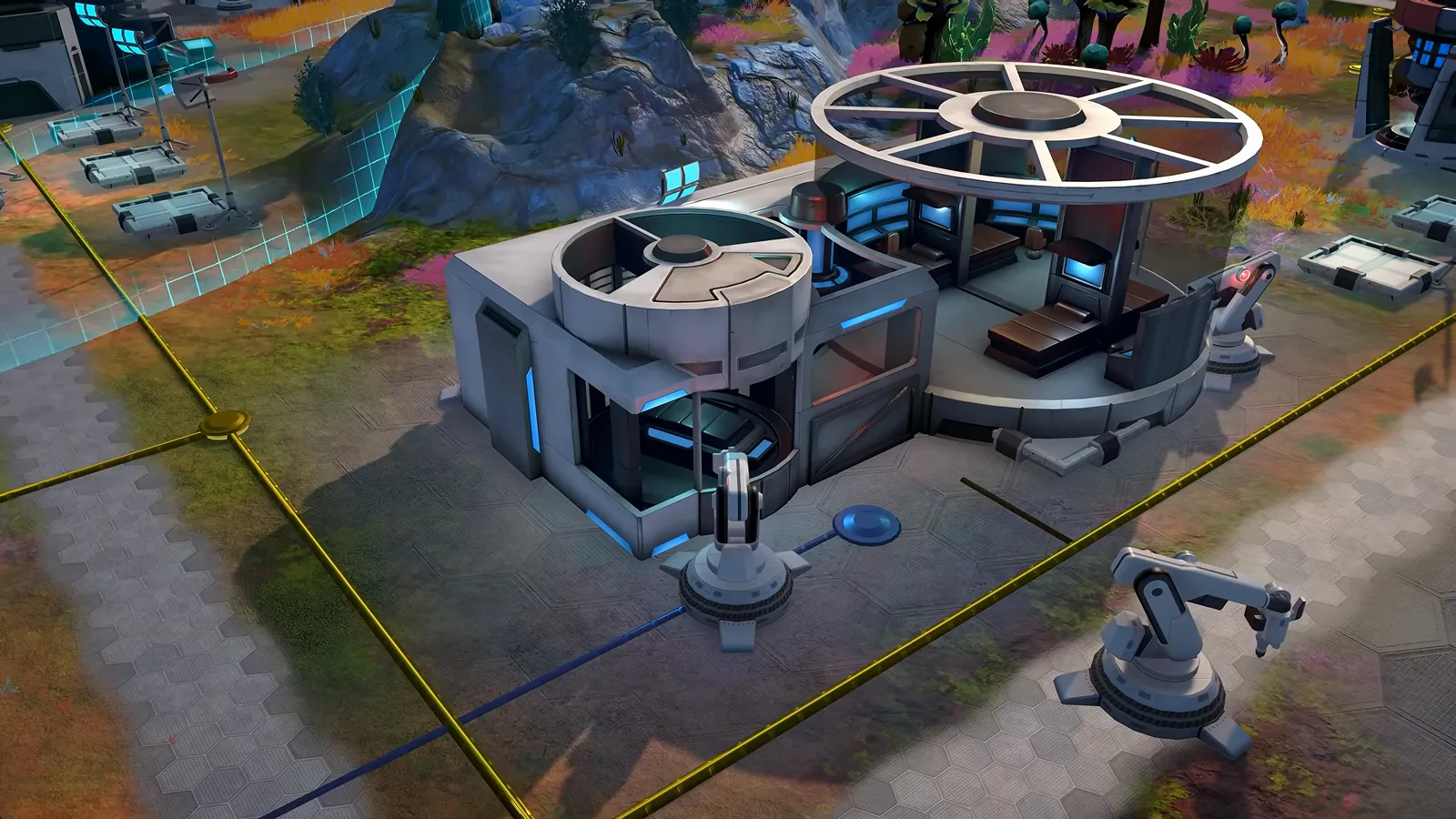 Official gameplay footage of a large two-part building with a round open-roof section, a robotic arm beside it and yellow lines running across the ground